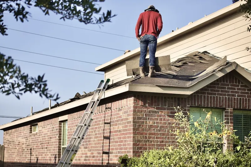 Professional roofer working on a residential roof in Evergreen Estates